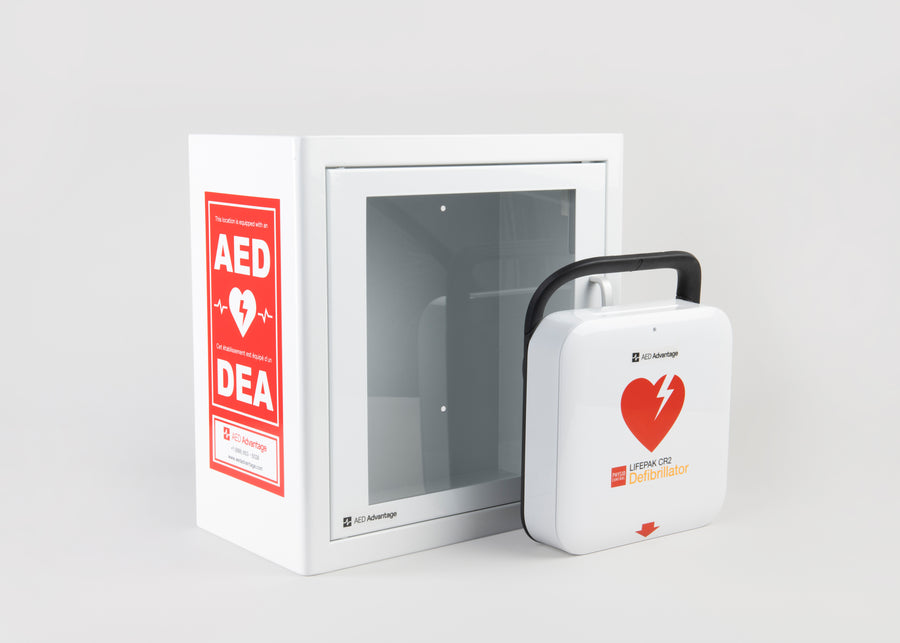 A white and red LIFEPAK CR2 AED machine standing in front of a white metal aed cabinet with red decals