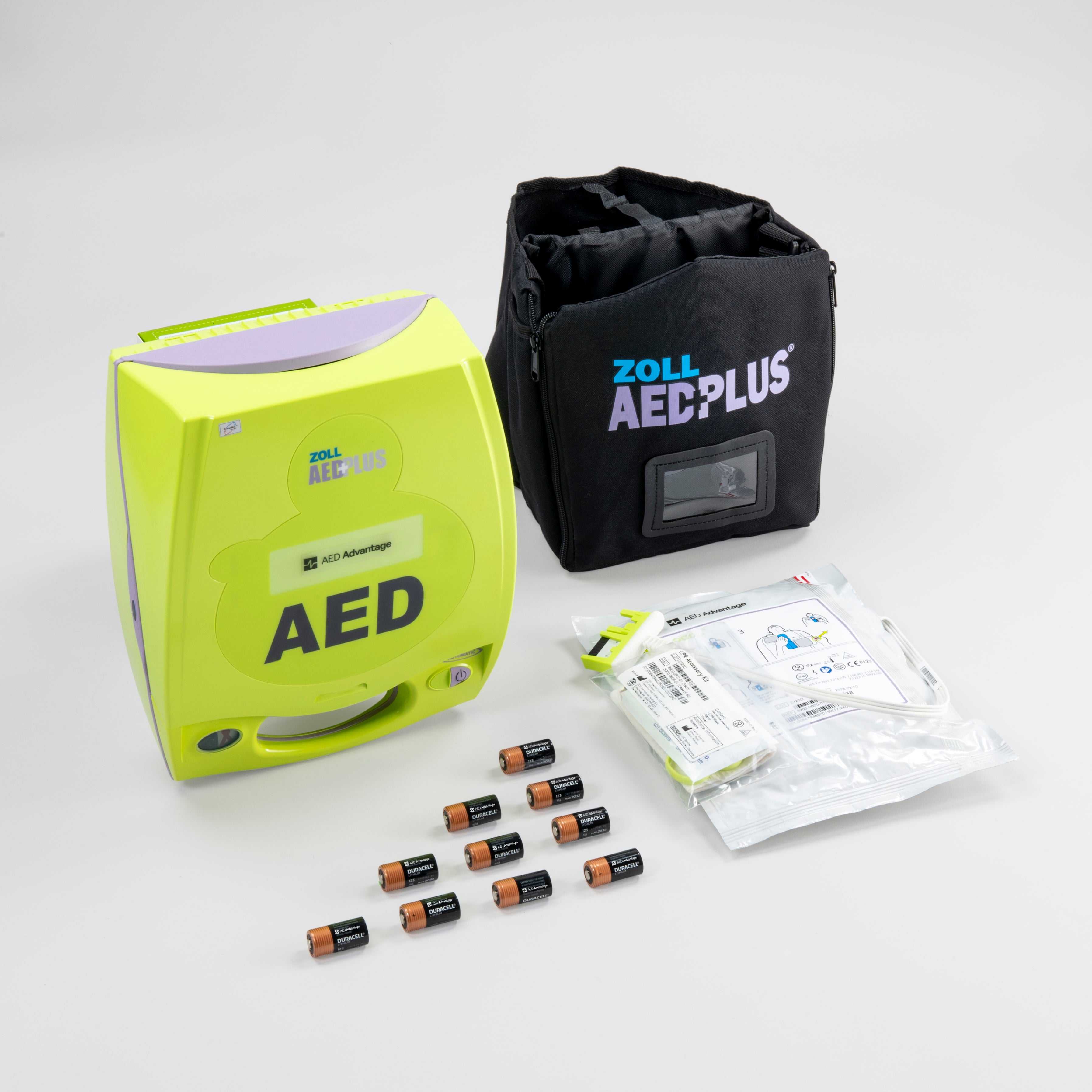 A bright green ZOLL AED with its carry case, batteries, and electrodes