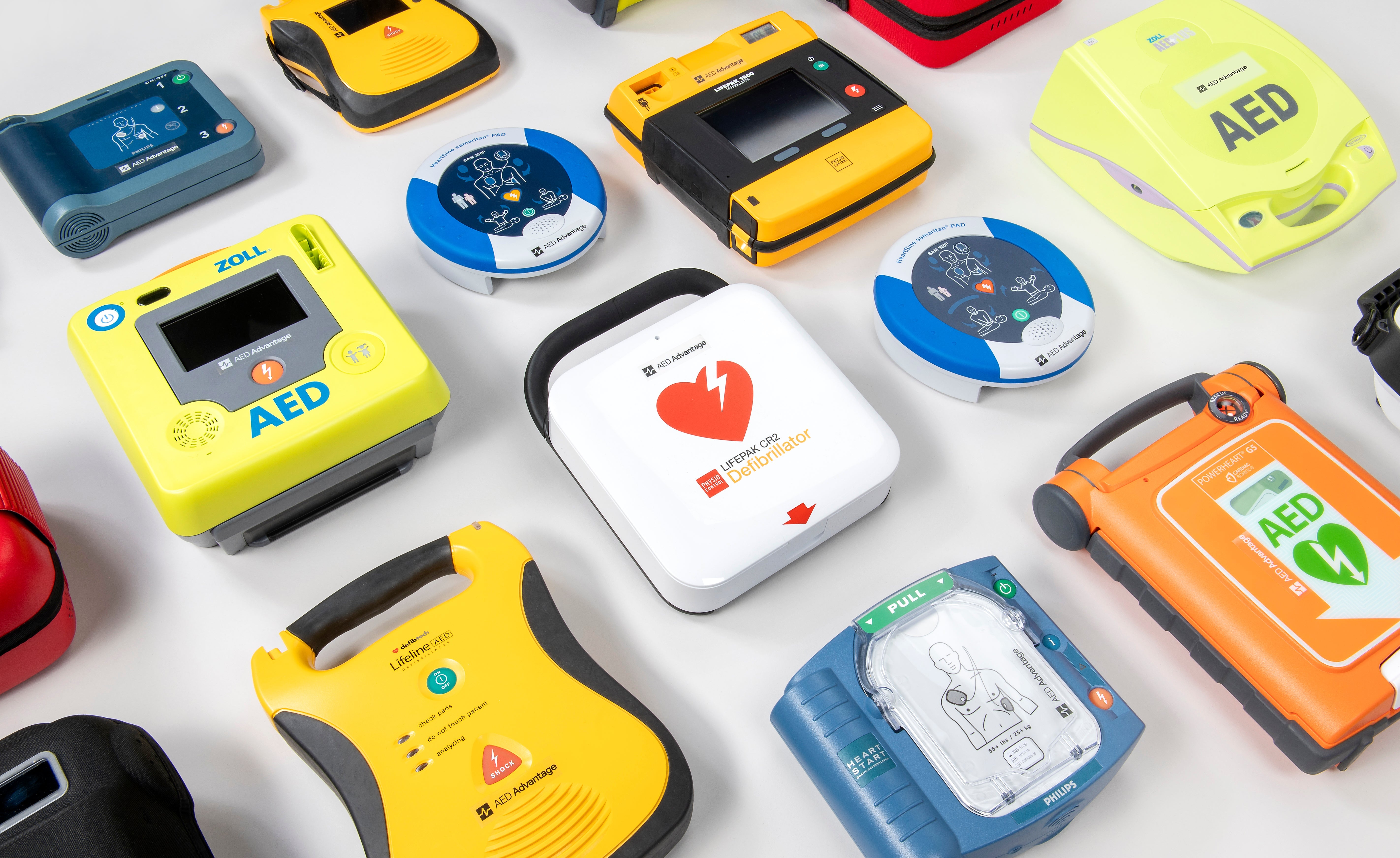 A collage of AEDs of various colours, shapes, and sizes