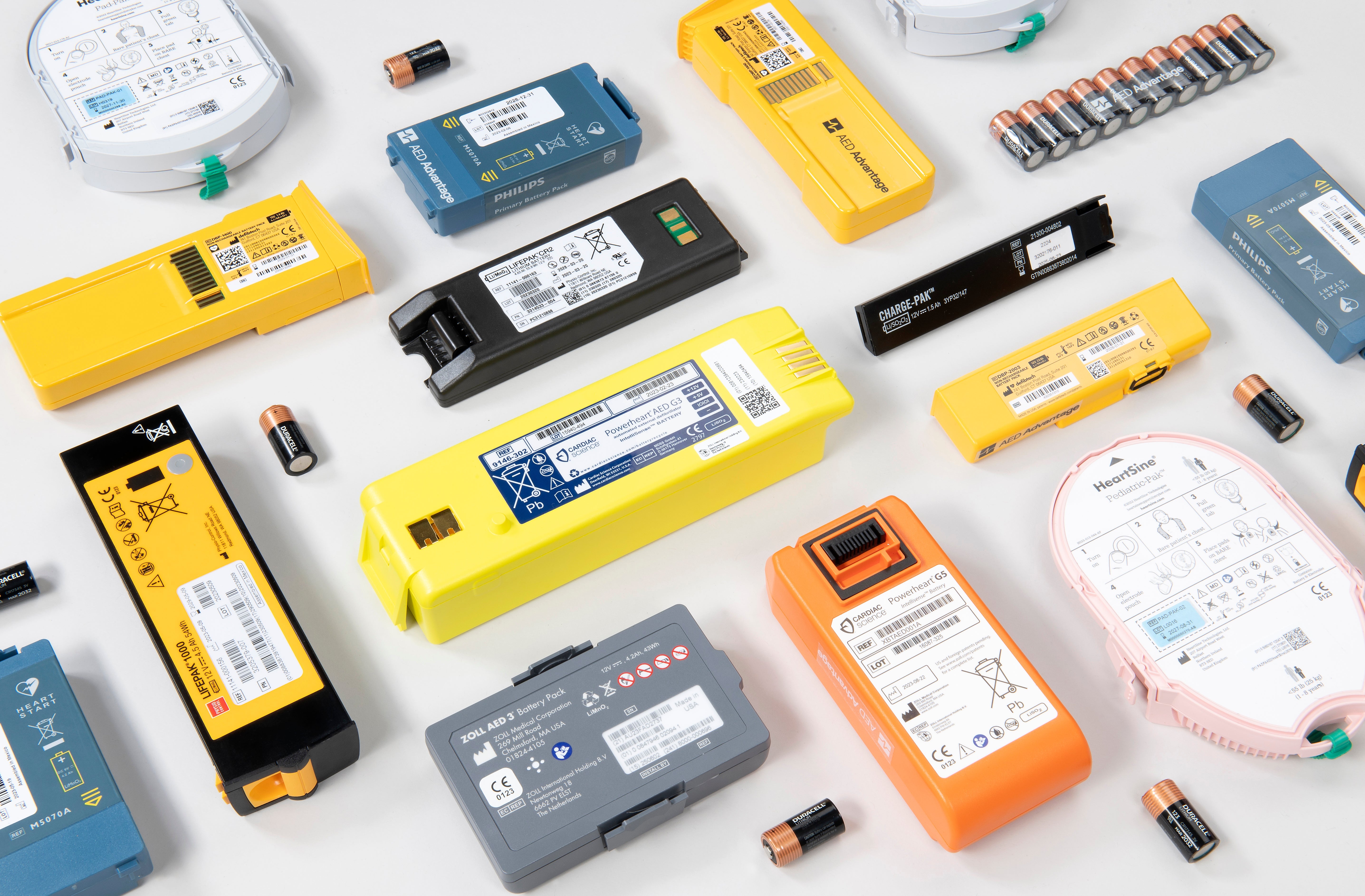 A collage of AED batteries of various colors, sizes, and shapes