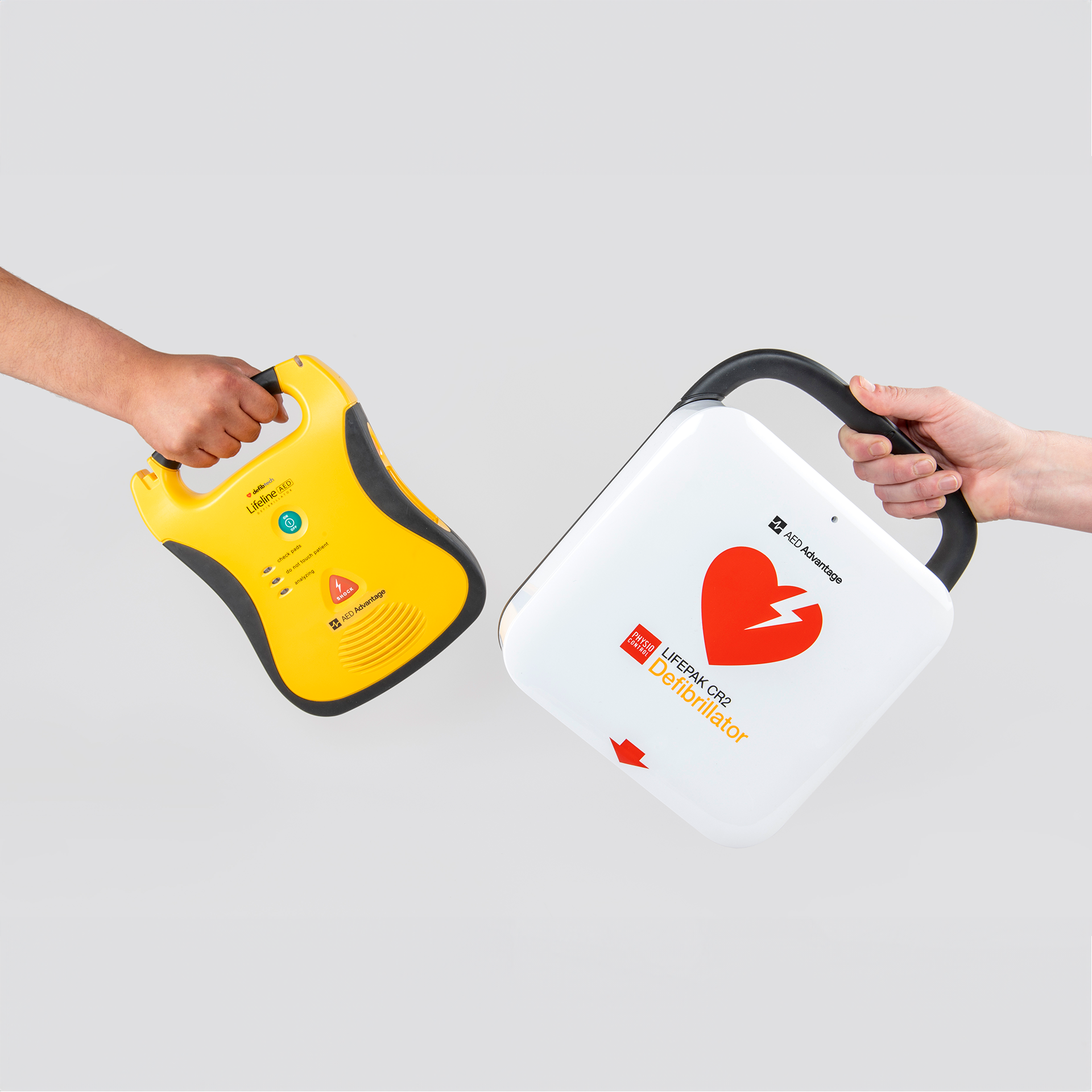 Two AEDs being exchanged from one hand to another. 