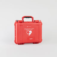 A bright red rectangular hardcase with a handle meant for use with Philips defibrillators