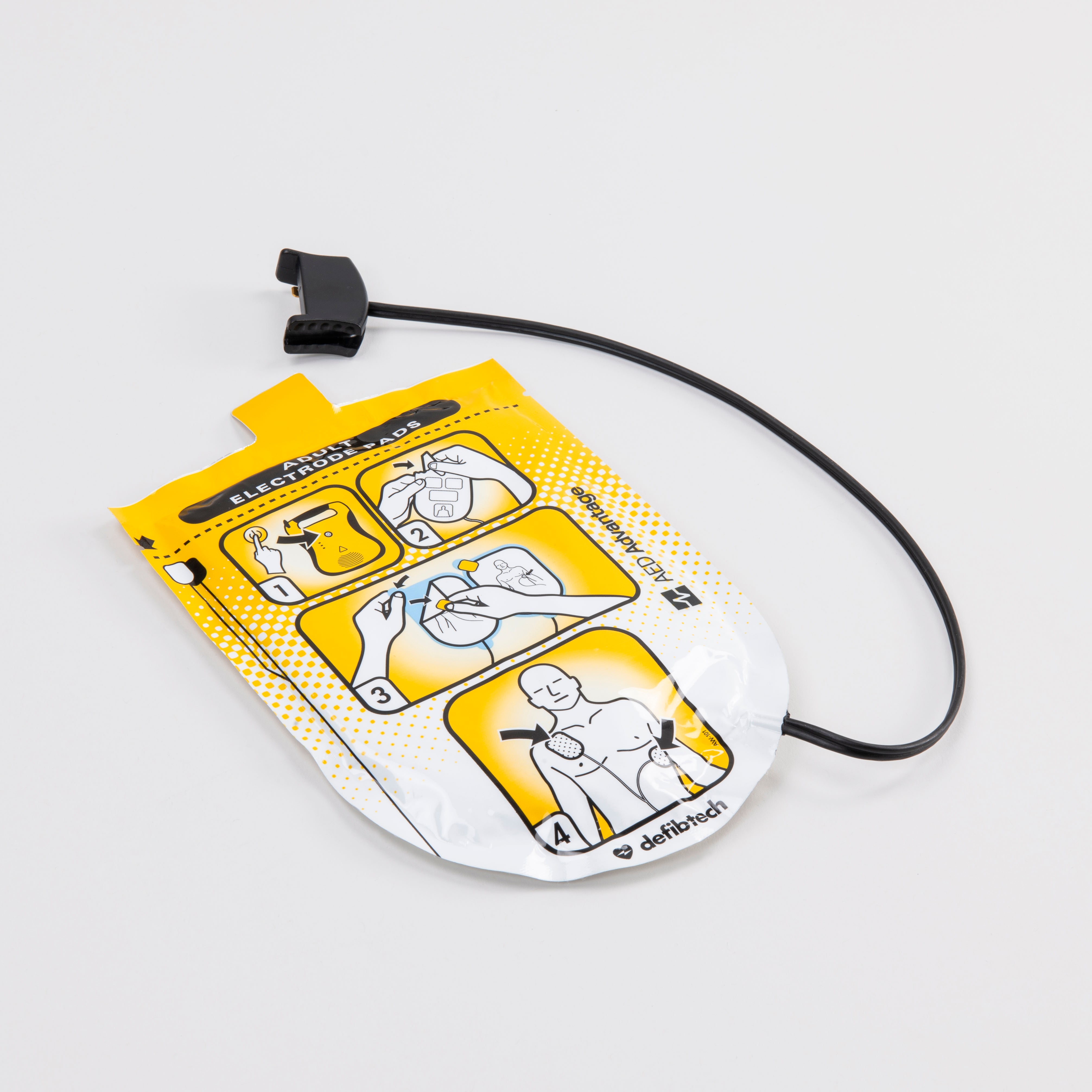 A set of adult Defibtech Lifeline electrodes encased in their yellow foil wrap with a black connector cord