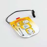 A set of adult Defibtech Lifeline VIEW AED electrodes encased in their yellow foil wrap with a black connector cord