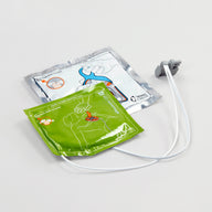 Green and white square foil packages containing CPR feedback electrodes for the Powerheart G5 defibrillator
