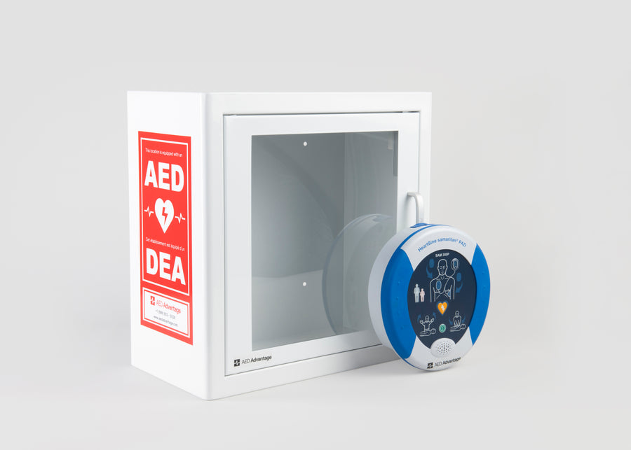 A blue and white HeartSine 350P AED standing in front of a white metal cabinet with red decals