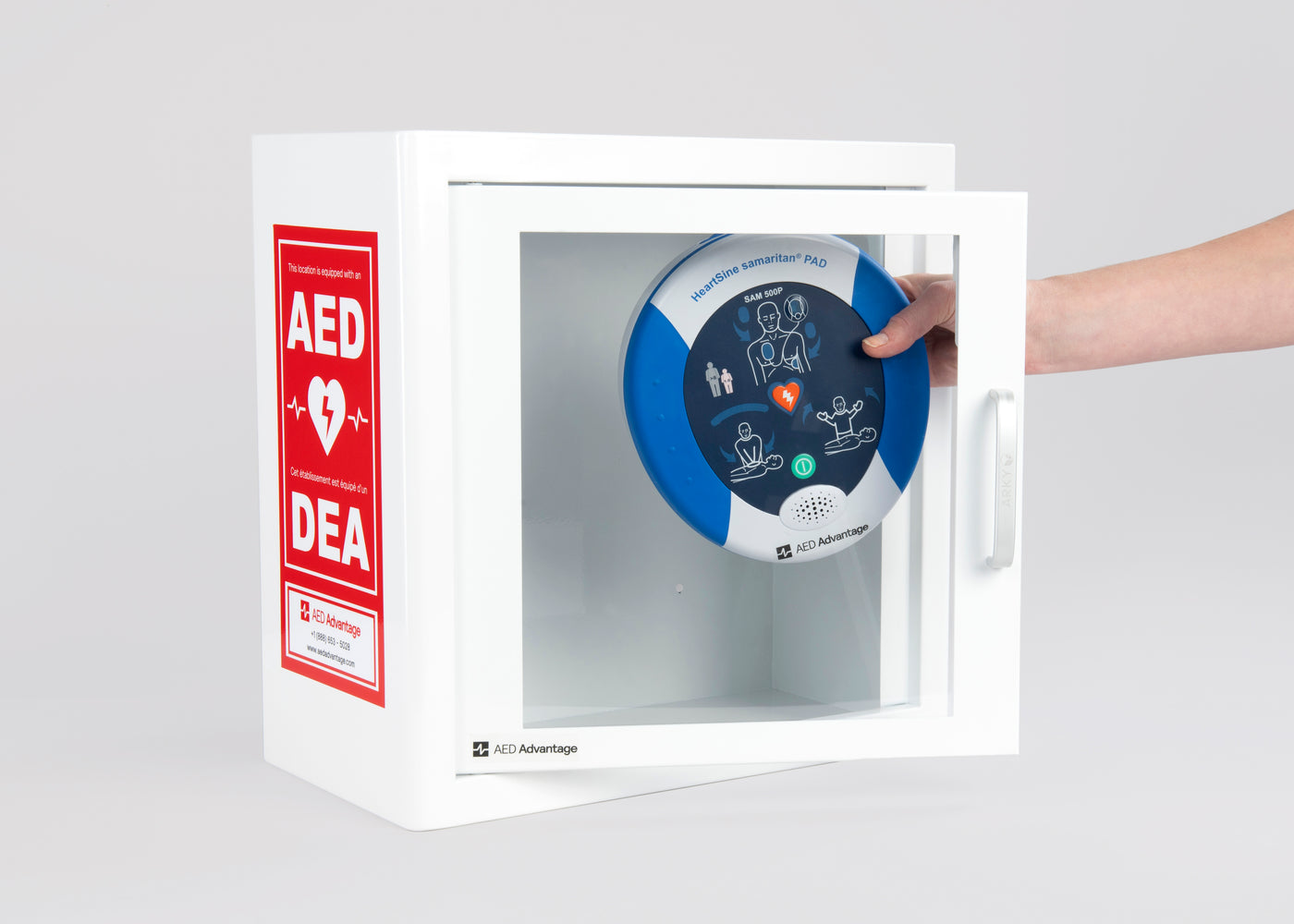A blue and white HeartSine 500P AED being retrieved by hand from a white metal cabinet with red decals