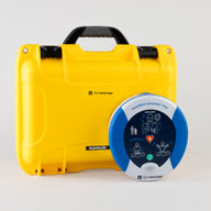 A blue and gray HeartSine 500P AED standing next to a bright yellow hardshell carry case
