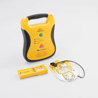 A black and yellow Defibtech Lifeline AED along with its battery pack and electrodes