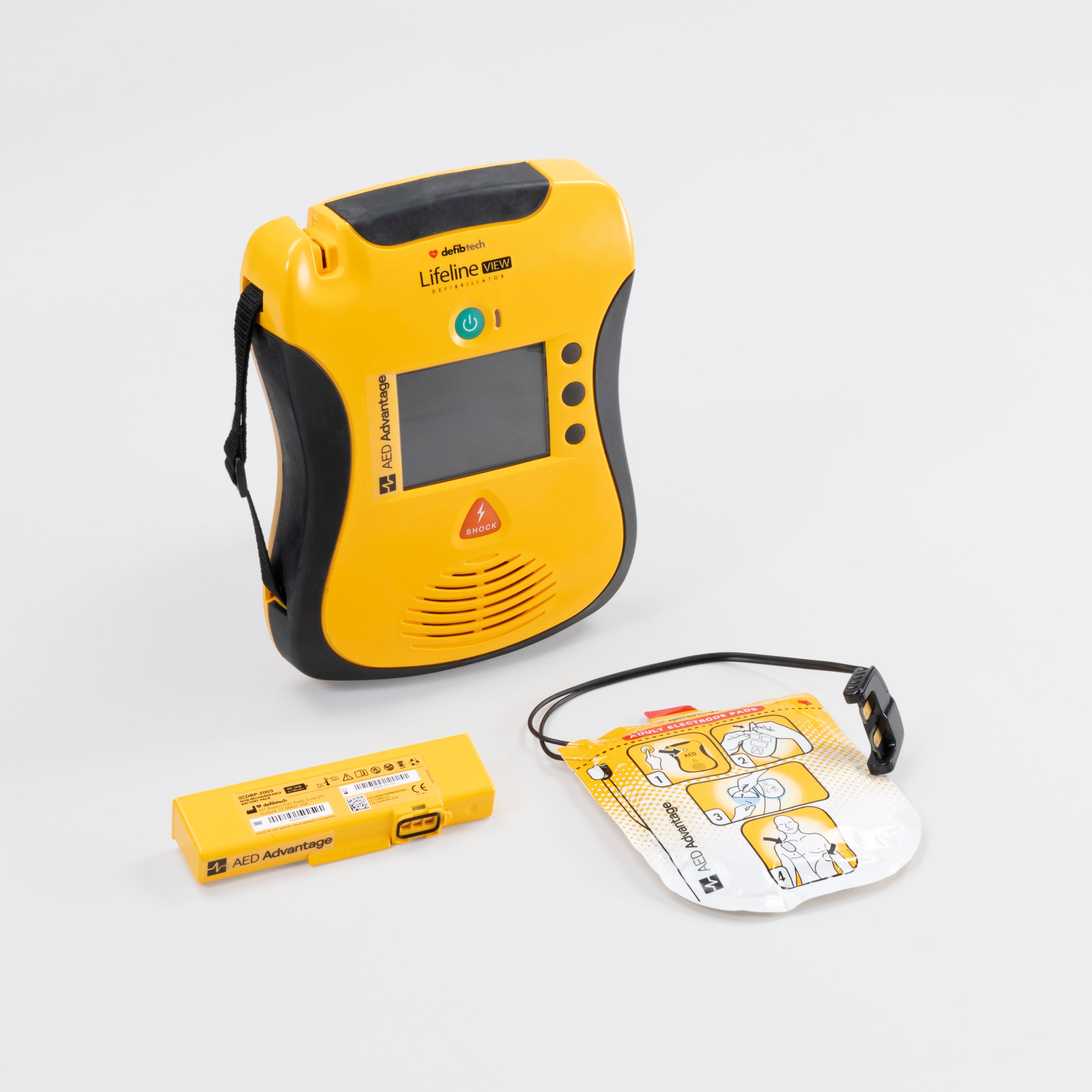 A yellow and black Defibtech Lifeline View AED with it's battery pack and electrodes