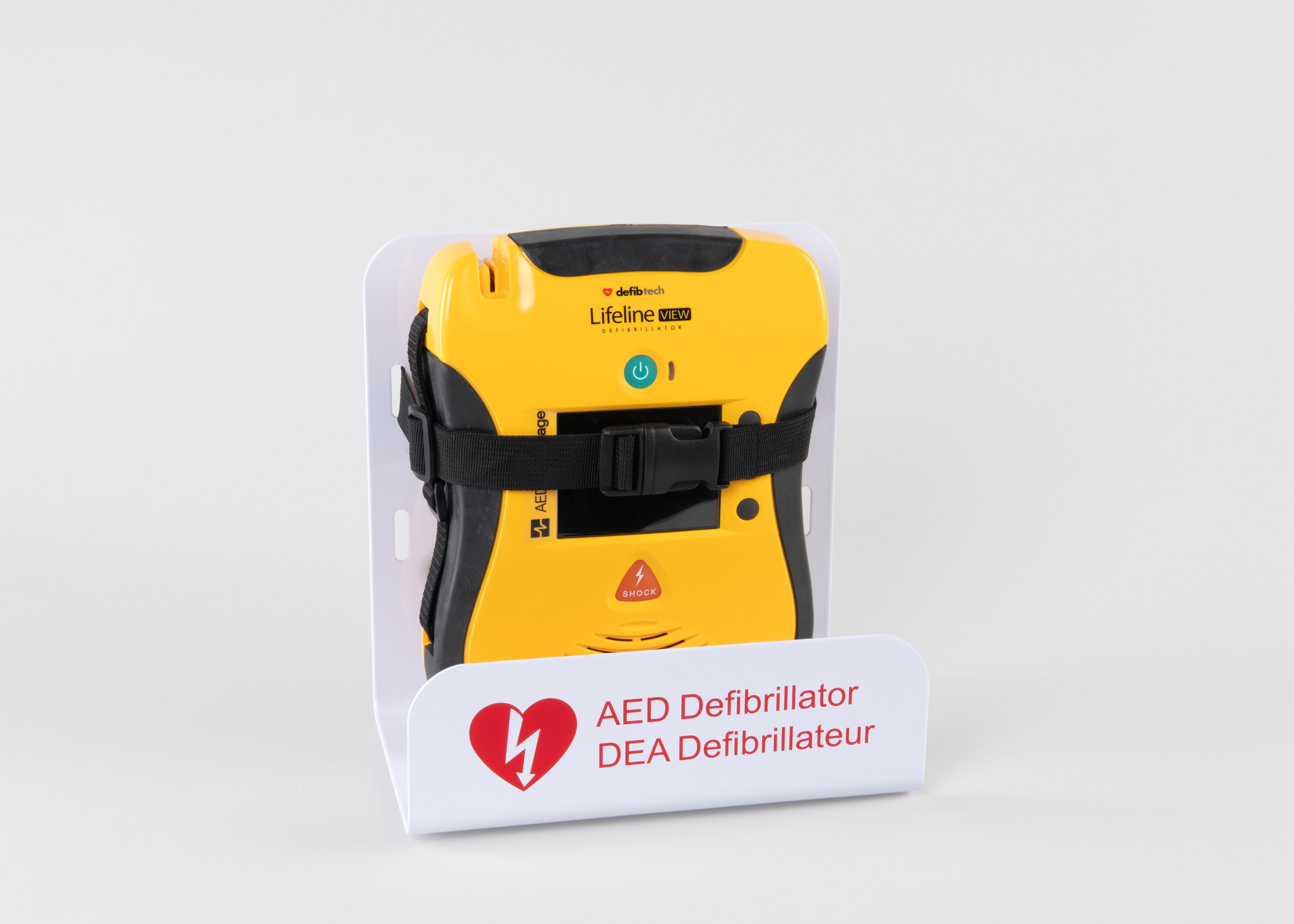 A black and yellow Defibtech Lifeline VIEW AED strapped into a white metal wall mount bracket