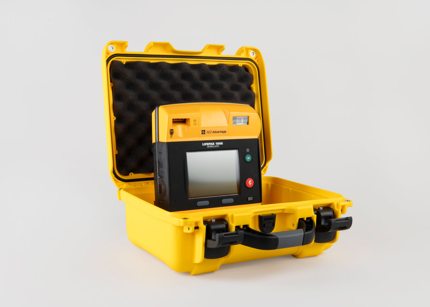 A black and yellow LIFEPAK 1000 AED machine inside a bright yellow hardshell carry case