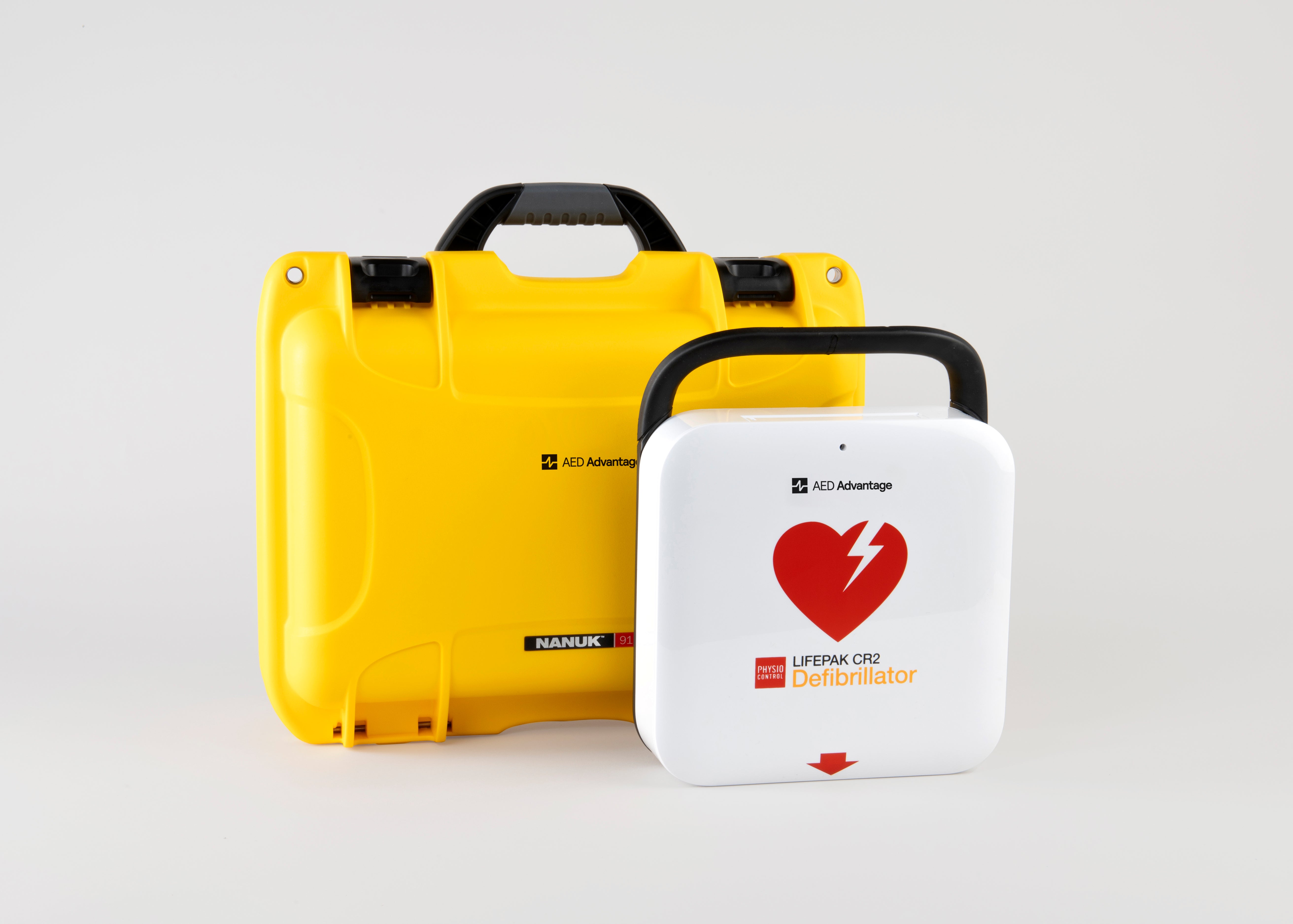 A white and red LIFEPAK CR2 AED machine and a bright yellow hardshell carry case