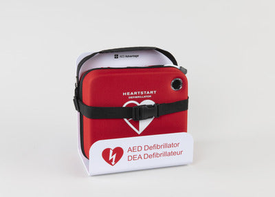 A red Philips OnSite AED strapped in a white universal wall mount bracket.