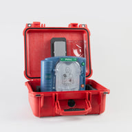 A blue Philips OnSite AED machine inside a bright red hardshell carry case