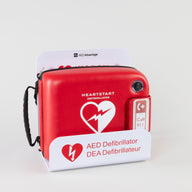 A Philips FRx AED in a bright red carry case displayed in a white metal wall mount bracket