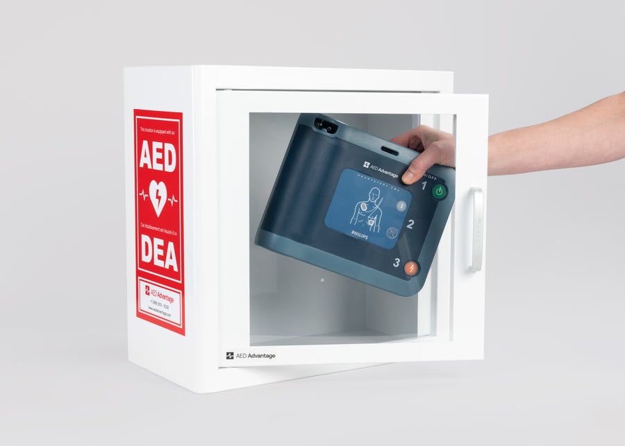 A blue Philips FRx AED being retrieved by hand from a white metal cabinet with red decals