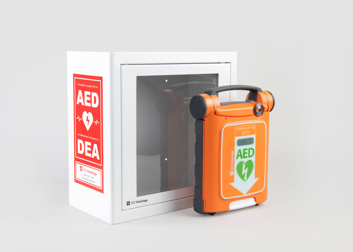 An orange Powerheart G5 AED standing in front of a white metal cabinet with red decals