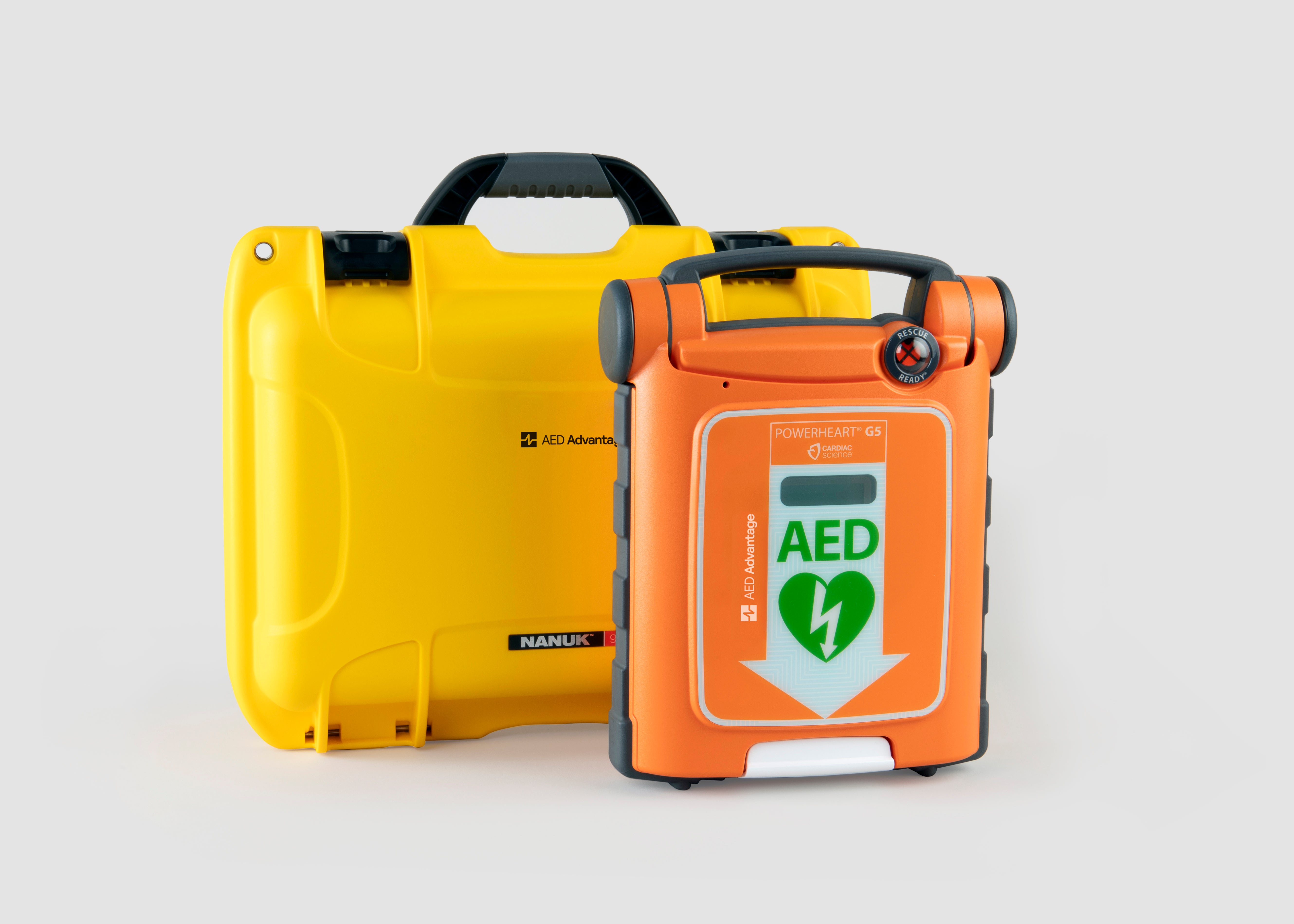 An orange Powerheart G5 AED standing next to a bright yellow hardshell carry case