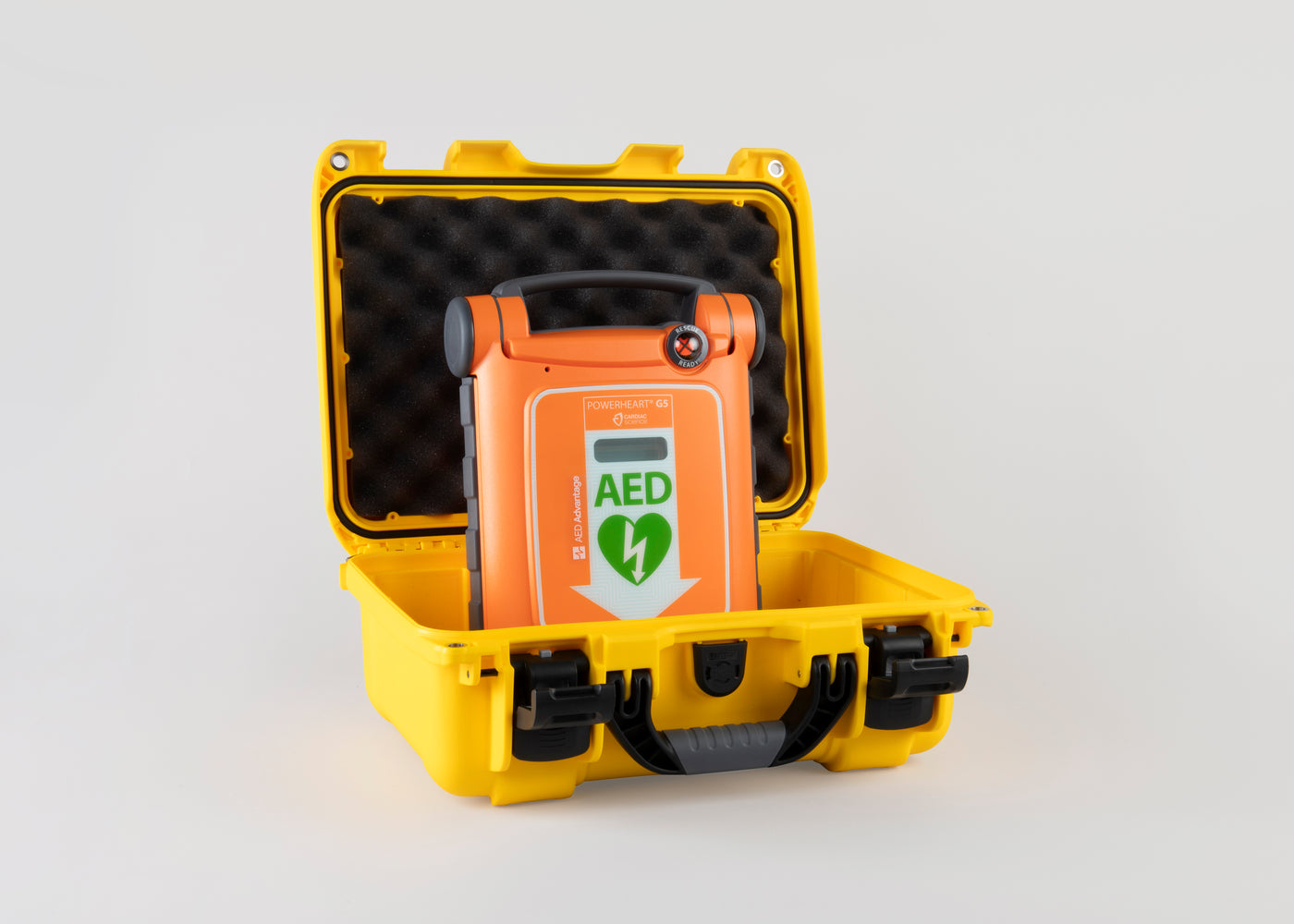 An orange Powerheart G5 AED inside a bright yellow hardshell carry case