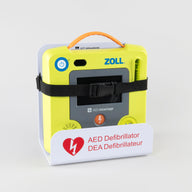 A green ZOLL AED 3 machine strapped into a white metal wall mount bracket