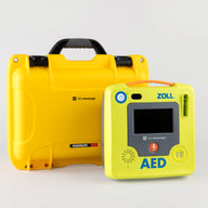 A green ZOLL AED 3 machine standing next to a bright yellow hardshell carry case