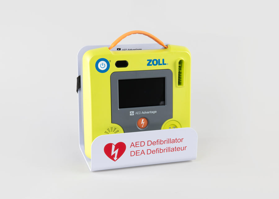 A green ZOLL AED 3 machine displayed in a white metal wall mount bracket