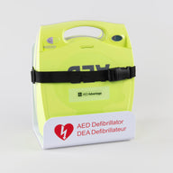 A green ZOLL AED Plus machine strapped into a white metal wall mount bracket