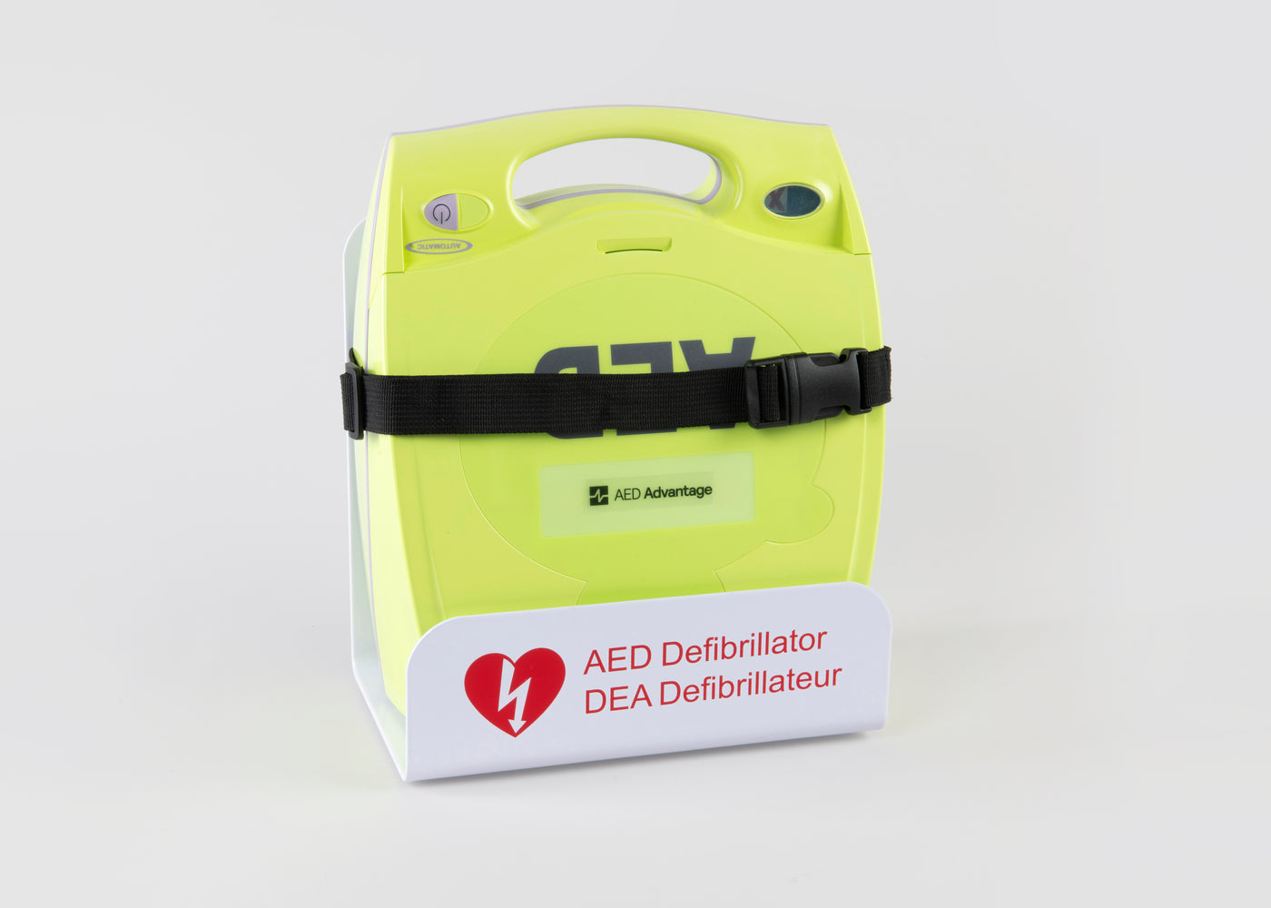 A green ZOLL AED Plus machine strapped into a white metal wall mount bracket