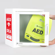 A green ZOLL AED plus machine being retrieved by hand from a white metal cabinet with red decals