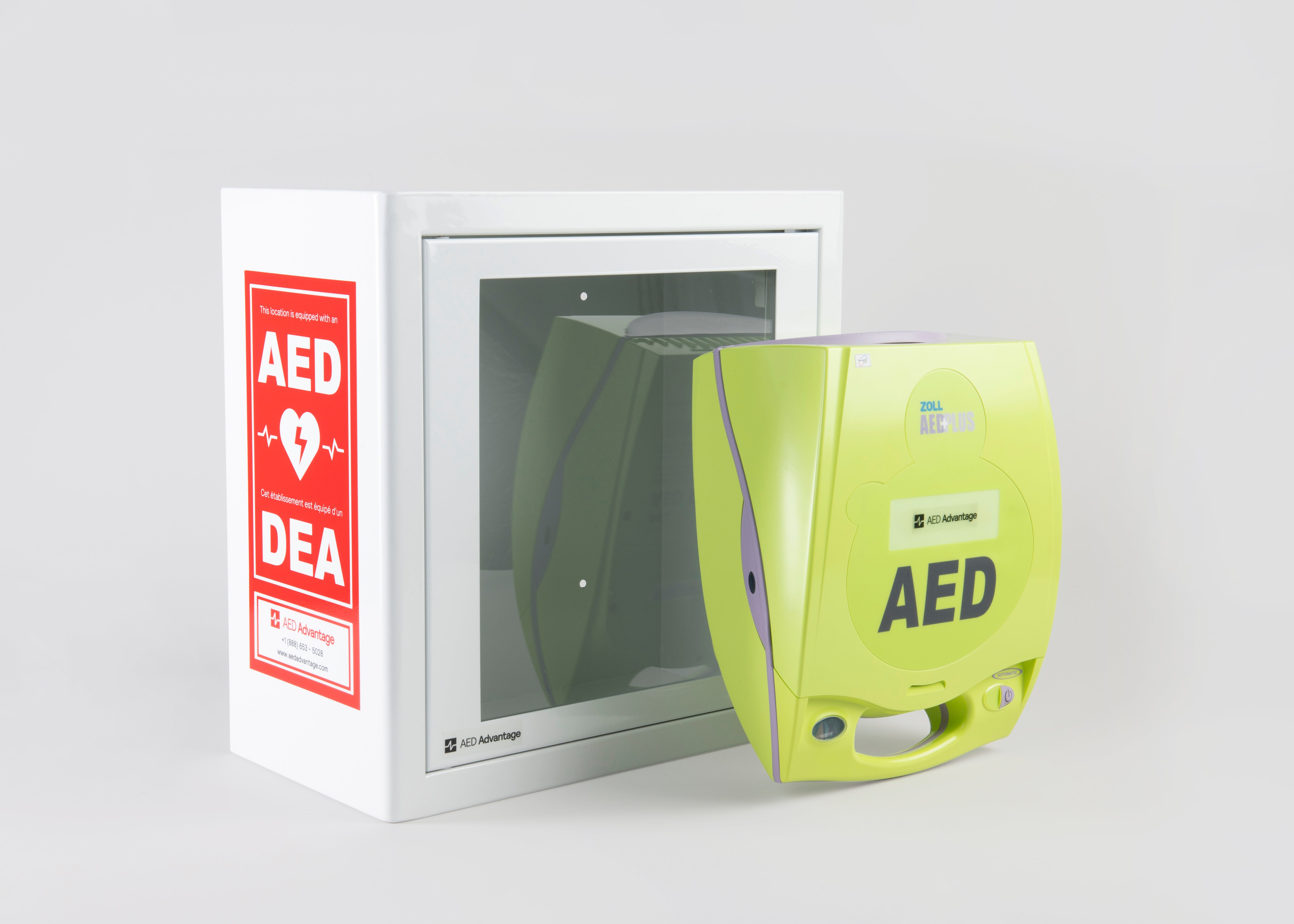 A green ZOLL AED Plus machine standing in front of a white metal cabinet with red decals