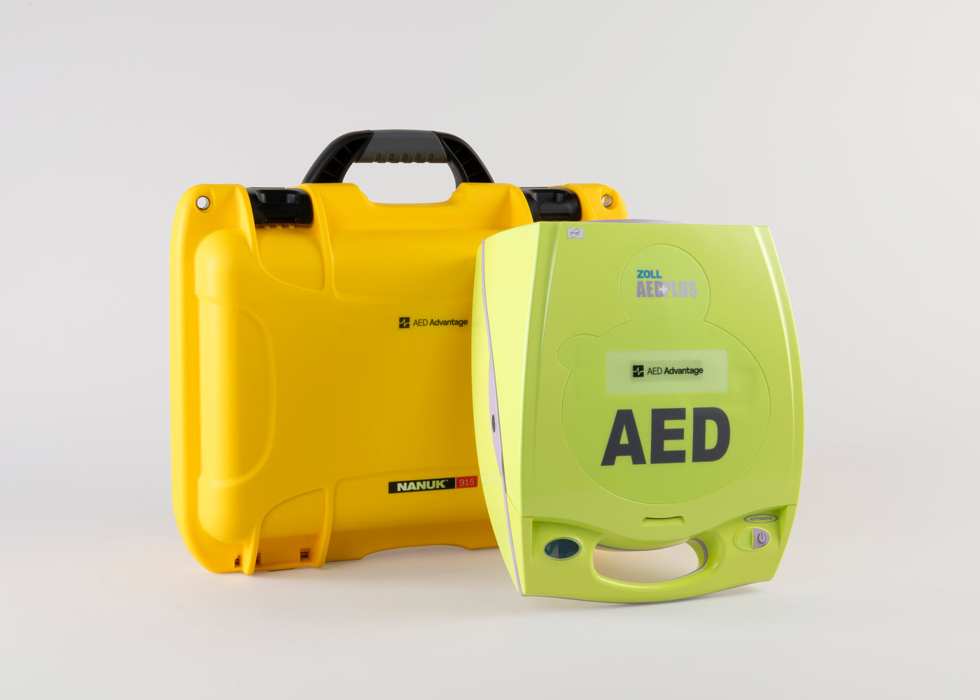 A green ZOLL AED Plus machine standing next to a bright yellow hardshell carry case