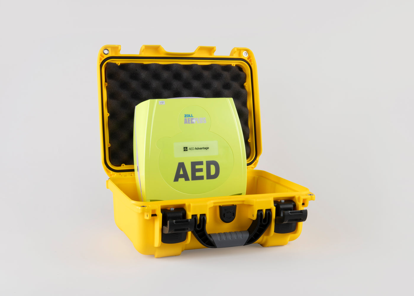 A green ZOLL AED Plus machine inside a bright yellow hardshell carry case